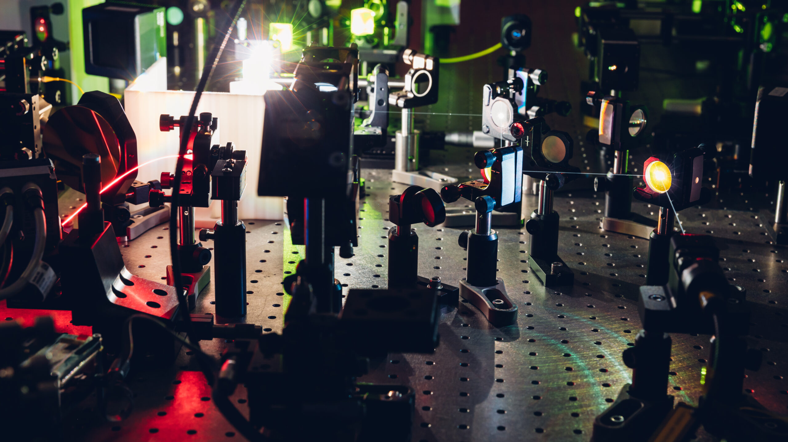 Experiment with laser device in optical laboratory. Experiment in optic lab with laser device. Experiment in optic lab with laser device.